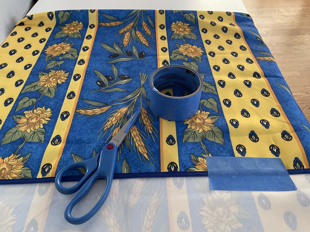 "Hem" a too-long tablecloth with blue painter's tape.