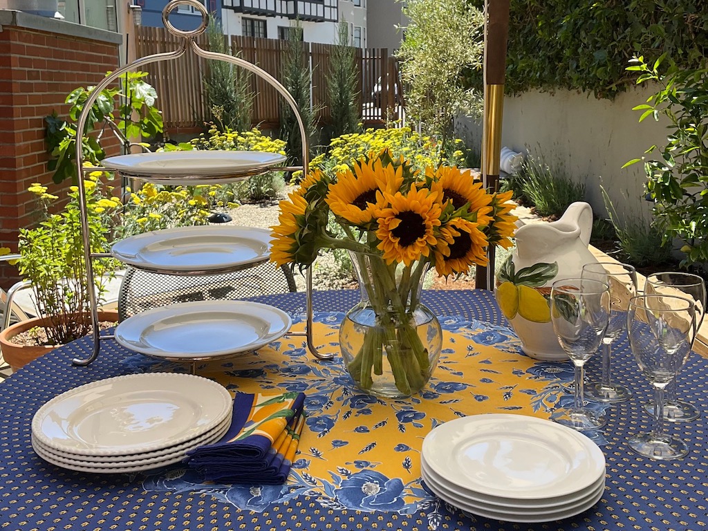 Set the table with special touches like a French tablecloth and tiered plate stand.