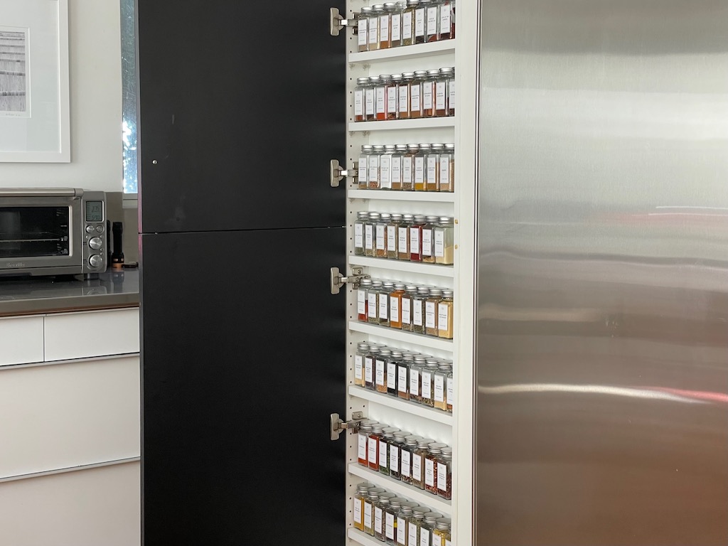 Spices, in new bottles, in the floor-to-ceiling pantry.
