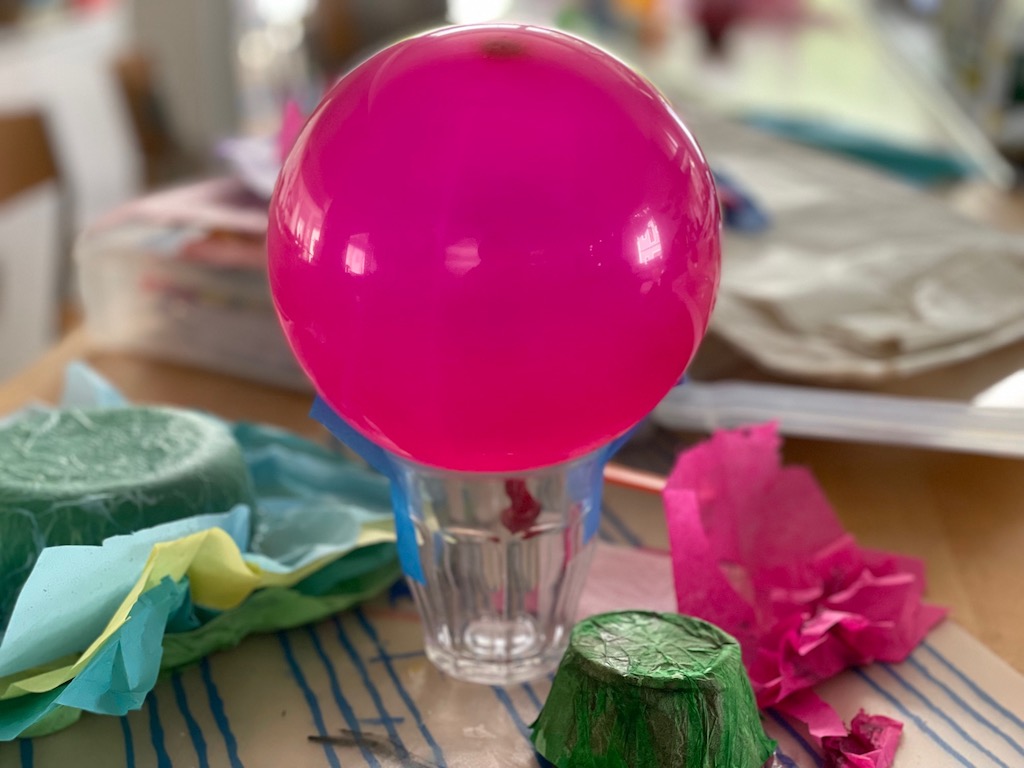 For the balloon method, tape the balloon to a heavy cup or mug.
