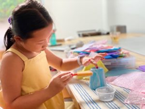 Use a cup as a mold to make a tissue paper bowl.