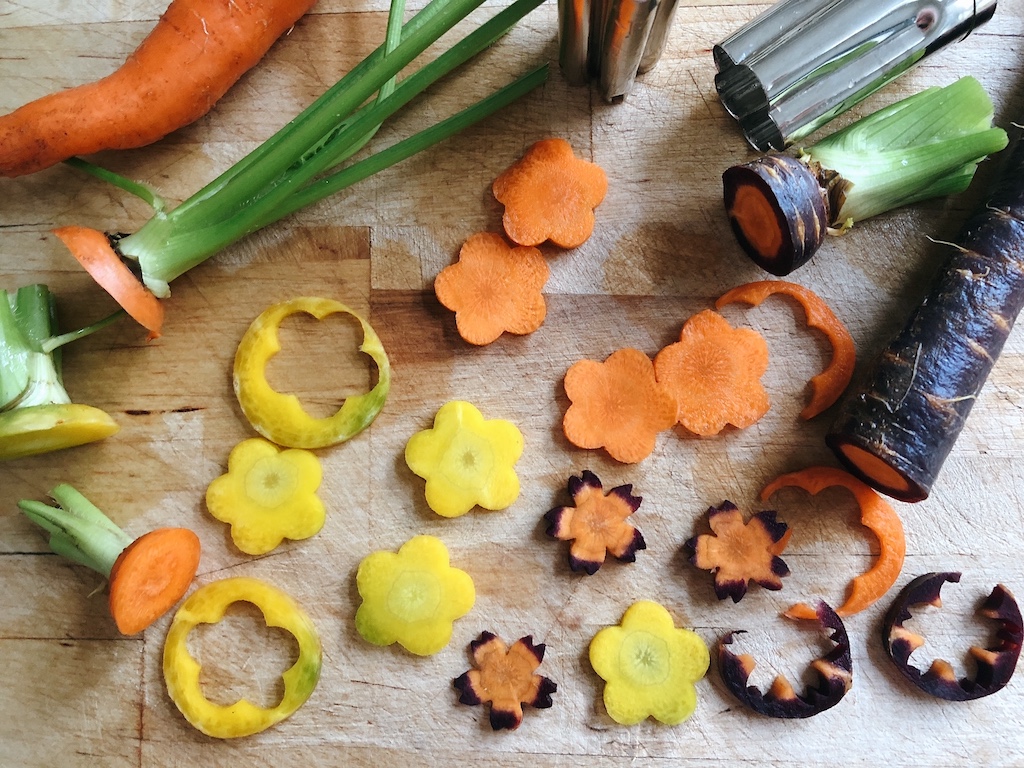 Multi-colored carrots are cut with flower vegetable cutters. You can use these cutters on firm cheeses, too.