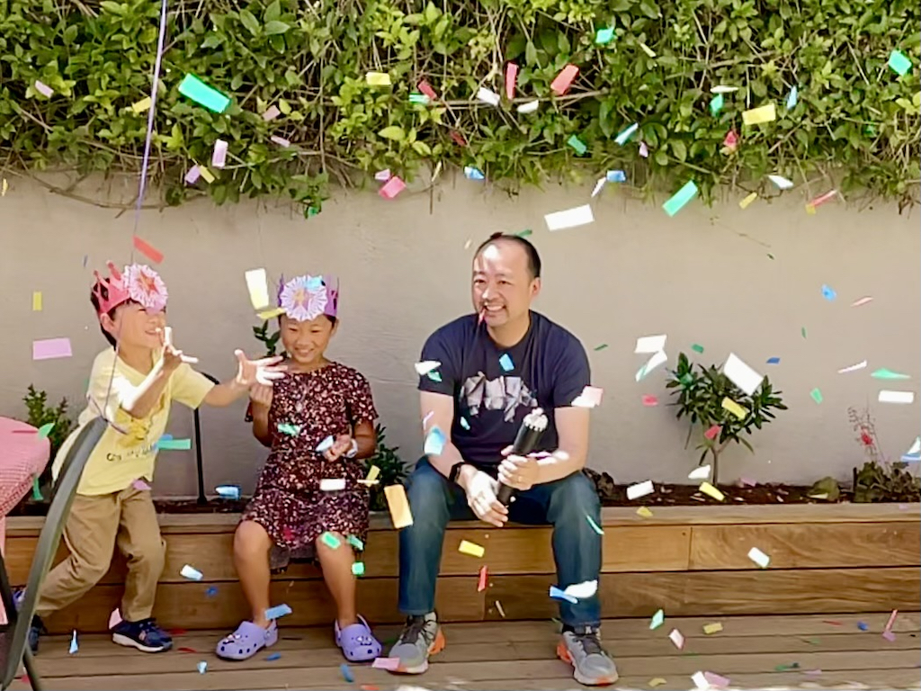 It's raining confetti from a confetti cannon at the ice cream party.