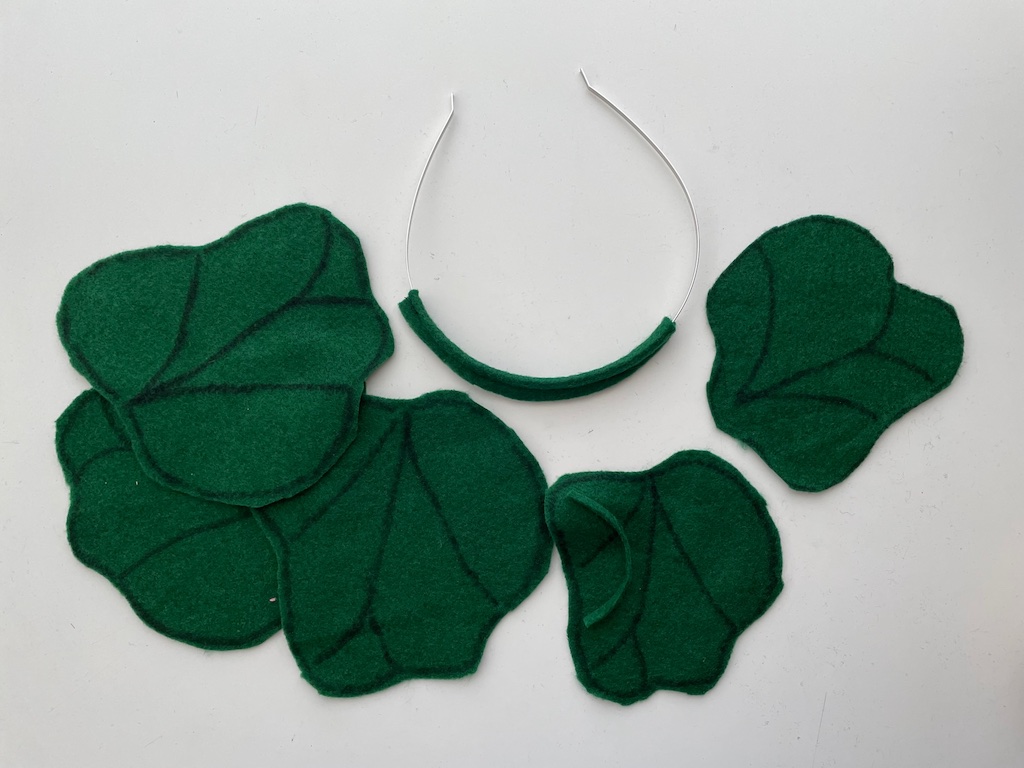 Cover a headband partially with green felt and stitch on pumpkin leaves.