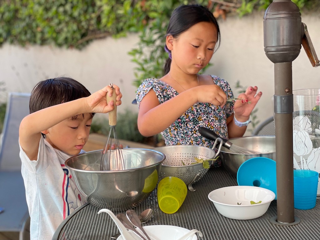 When it's too hot to cook, it's too hot to play. Send kids outdoors in the shade with pitchers of water to "cook" with and splash on themselves.