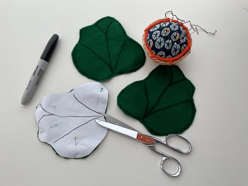 Trace the pattern on felt and cut out. Use a think black marker to draw the veins of the leaves and to trace the outline of each leaf.