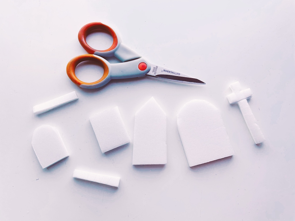 Styrofoam is cut into shapes for gravestones.