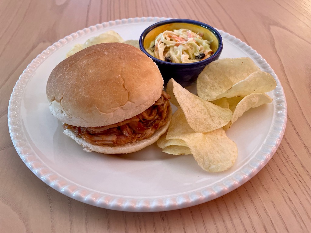 This turkey sandwich features shredded turkey heated in barbecue sauce and served in a soft roll.