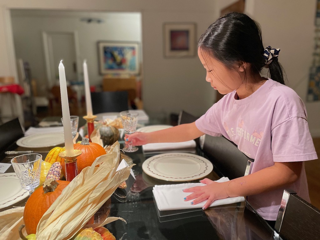 Child setting the table.