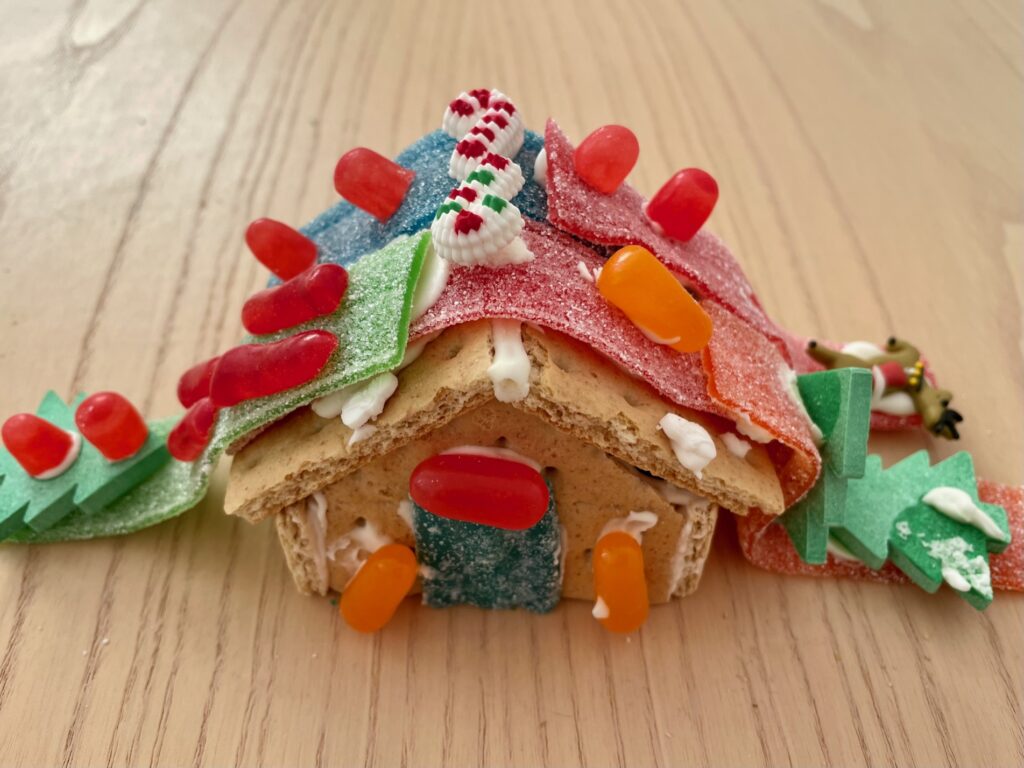 Gingerbread house with rooftop slides for Christmas trees and reindeer.