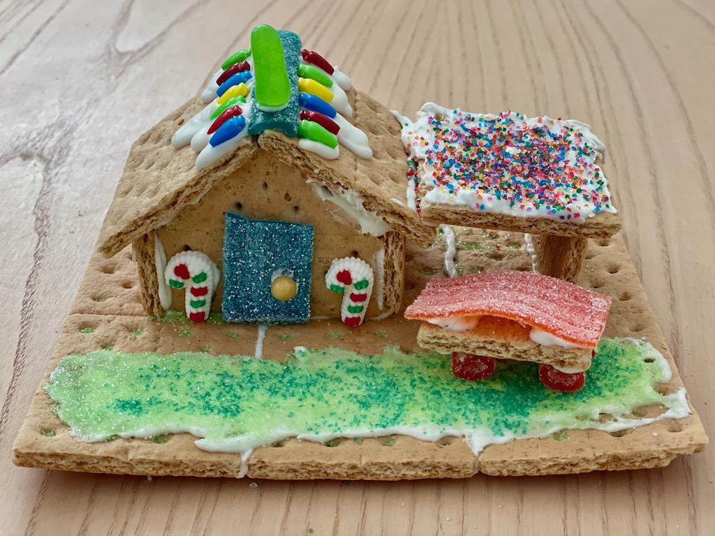 Gingerbread house with garage and gingerbread car.