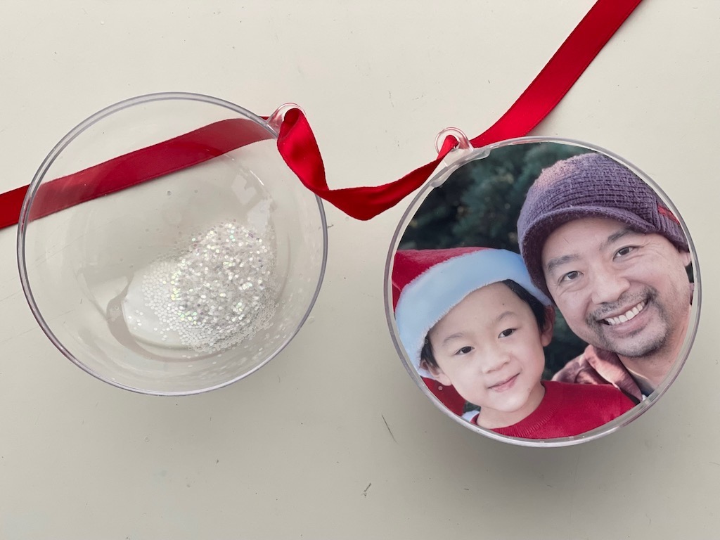 The DIY photo Christmas ornament deconstructed: photo, clear acrylic ball, and glitter.