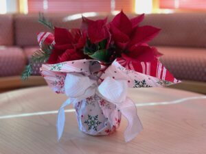 Fresh poinsettias arranged in a mason jar makes a last-minute holiday gift.