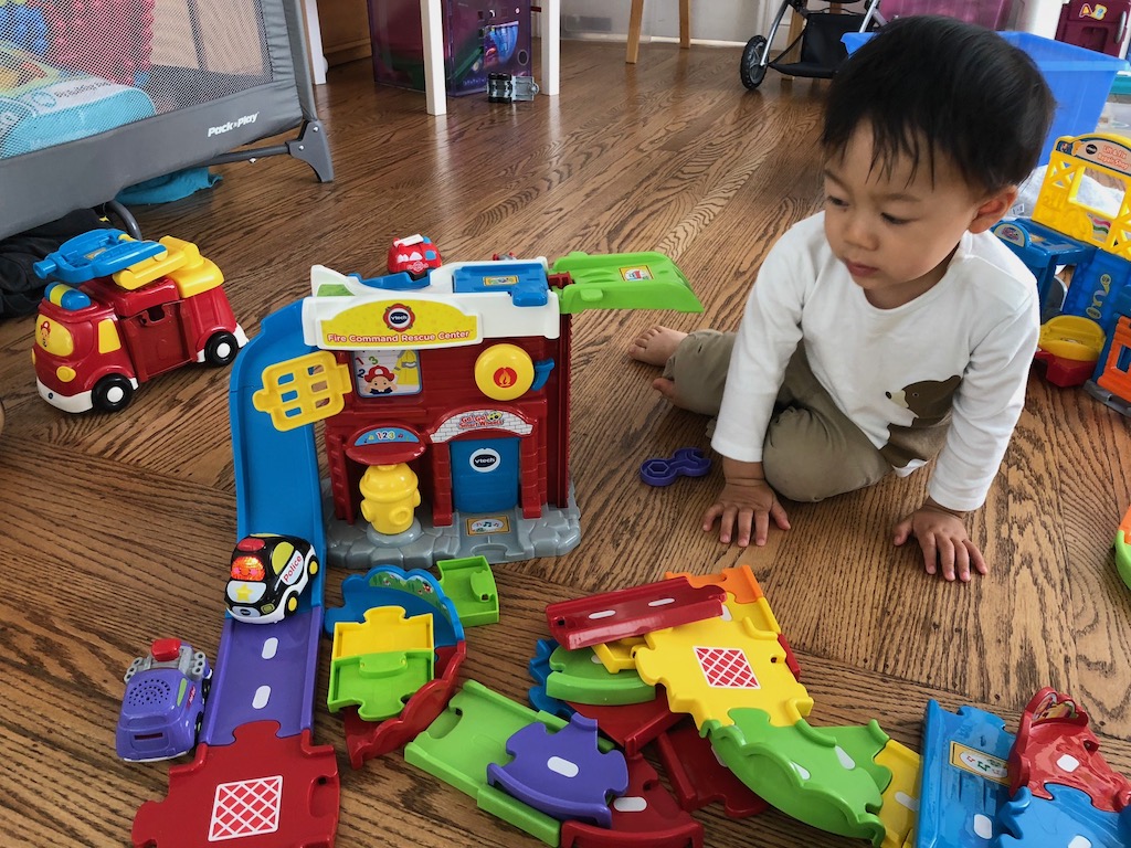 Child with firehouse play set. Grandma advice: To keep the parts intact, give these multi-piece toys to a friend so they stay intact.