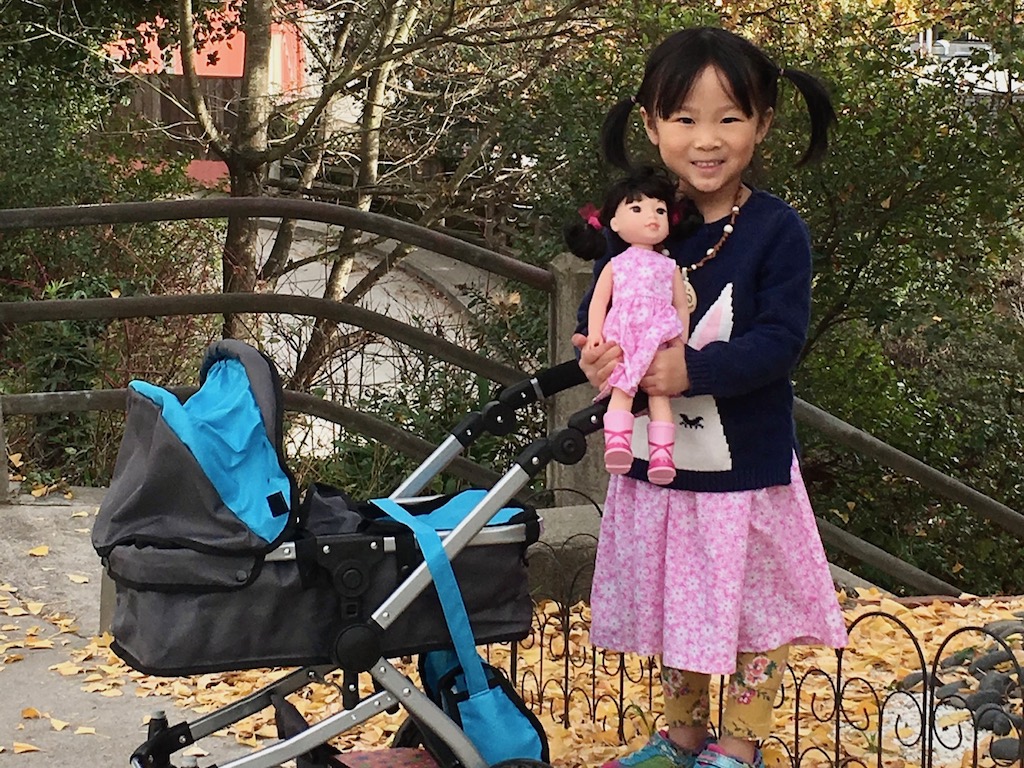 Child with doll and stroller. Grandma advice: donate the high-ticket items to such places as Goodwill.