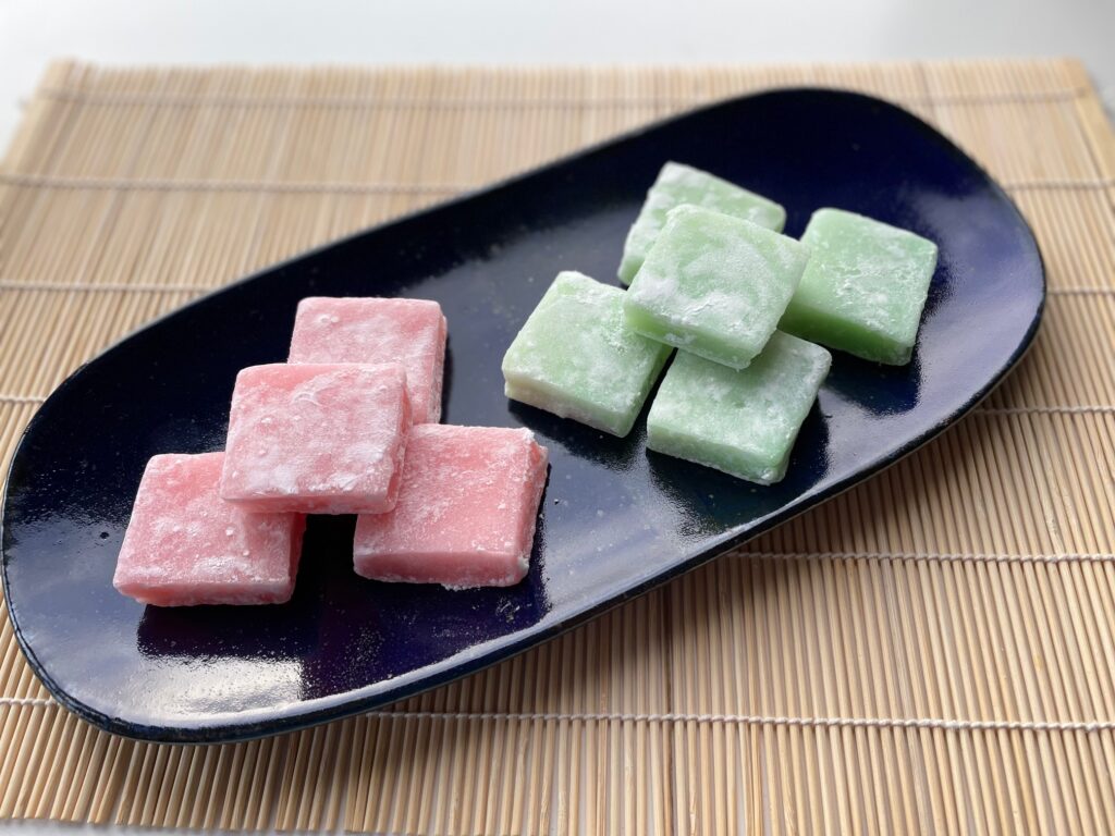 Pink and green chichi dango, pillowy squares of chewy sweetness.
