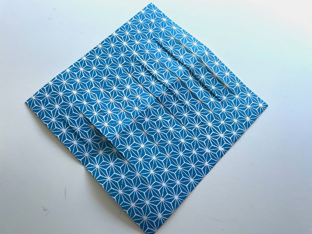 The origami paper showing the cut strips.