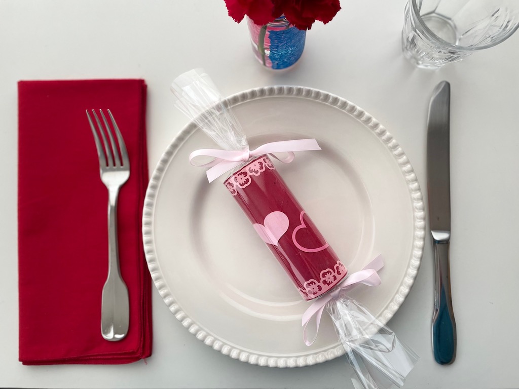 A valentine is put at every place setting for a family Valentine's Day dinner.