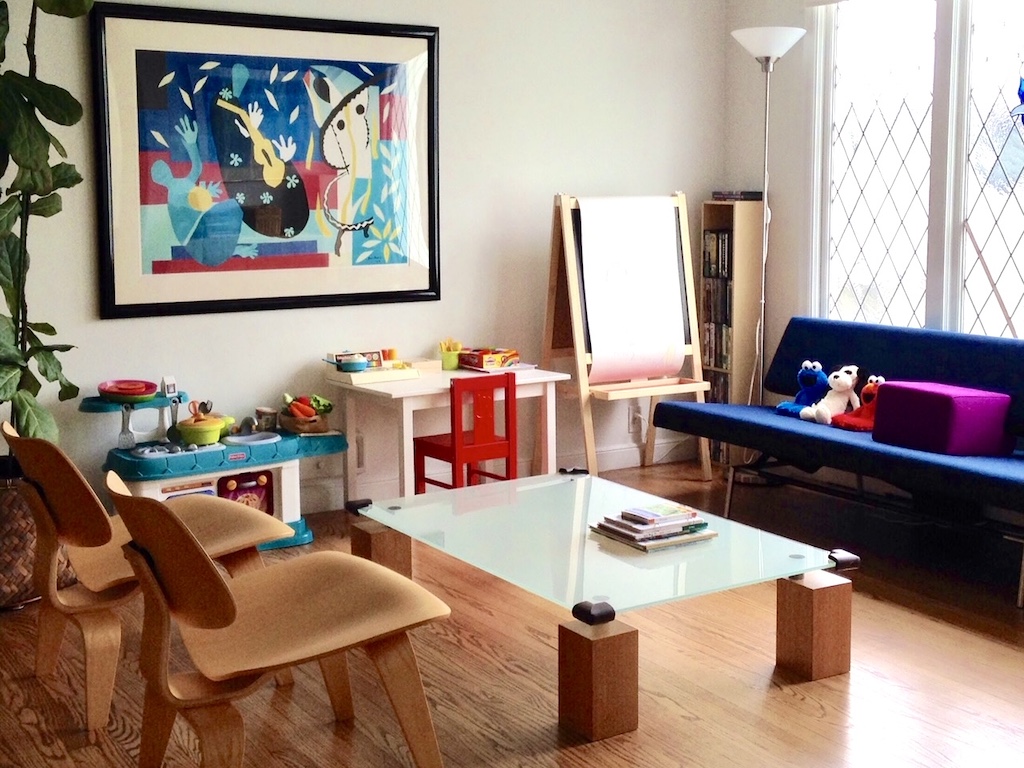 Family room converted into a playroom in 2015 shows kitchen and some of the toys kids have outgrown.