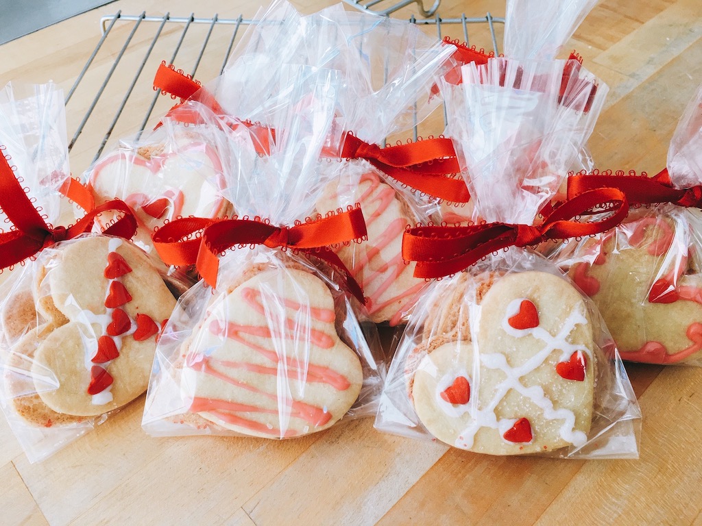 Homemade valentine cookies are packaged i. cellophane, ready to take to school.