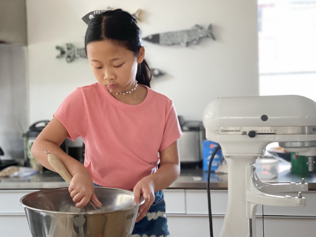 Child mixed up cookie dough during a day with grandma.