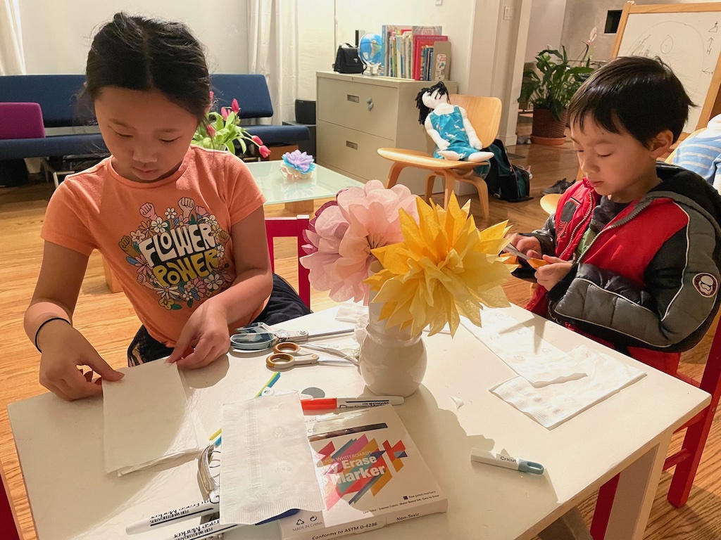 Kids make flowers from napkins, using the same technique.