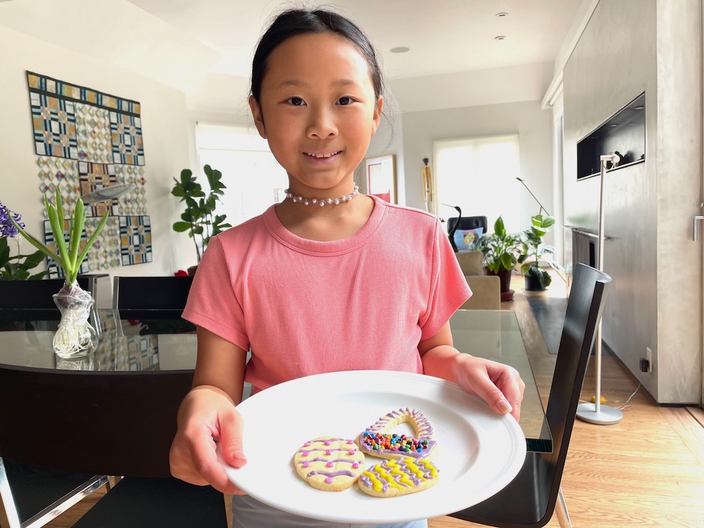 Child and her decorated sugar cookies.