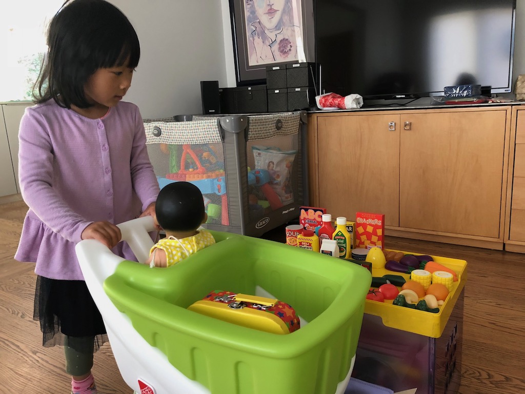 Child pushing shopping cart. Grandma advice: give such big-ticket items to goodwill for best donation.