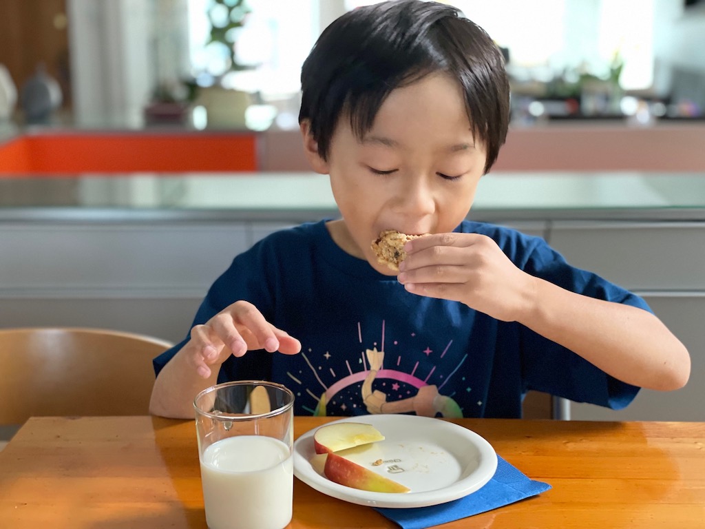 Child eats a nutritious after-school snack to develop healthy eating habits.