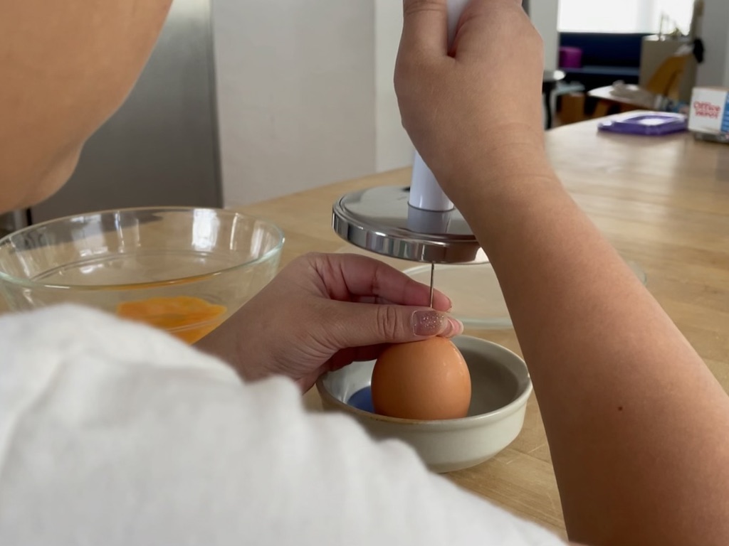 To blow out an egg, make holes in the top and bottom of an egg using a T-pin; tap with a meat mallet.