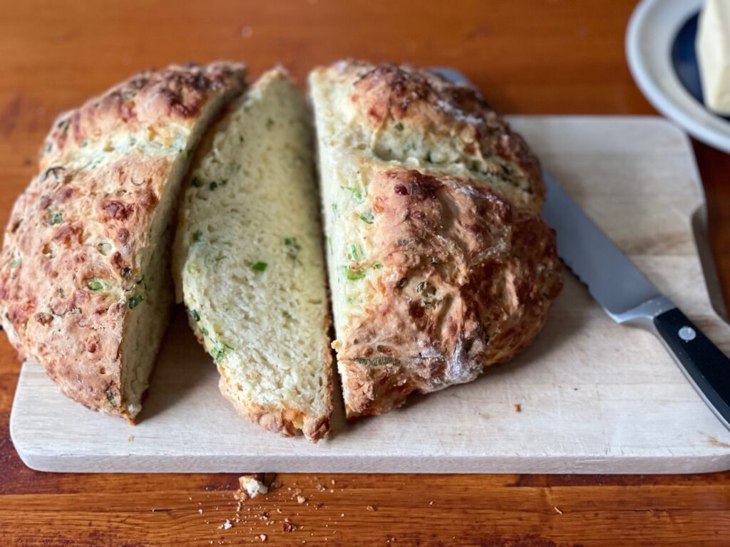 Easy Irish soda bread is studded with Dubliner cheese shreds and sliced green onion.