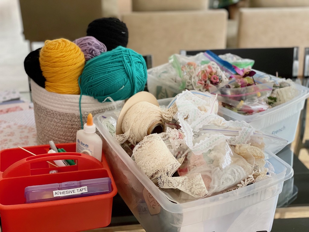 The supplies for egg dolls: lace, yarn, and artificial flowers.