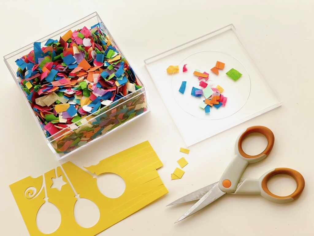 To make confetti from cardstock scraps, cut cardstock in strips, leaving a margin to hold the strips together, then cut crosswise.