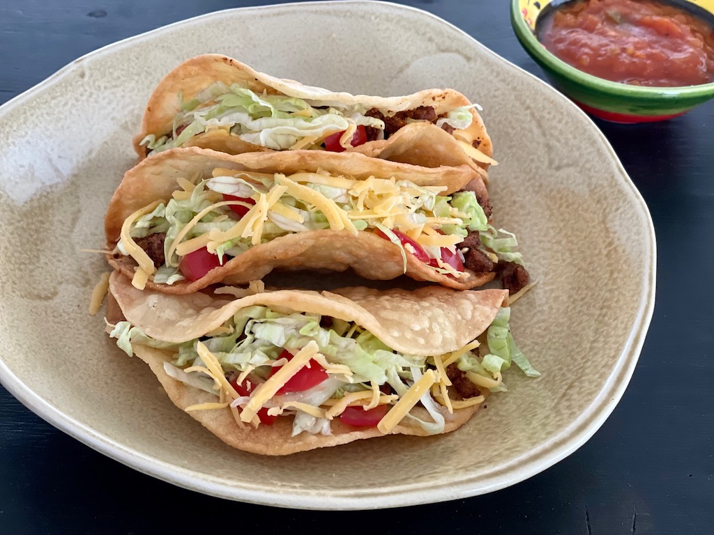 Old School Tacos are easy to make. Just combine ground meat with spice and brown in a skillet.