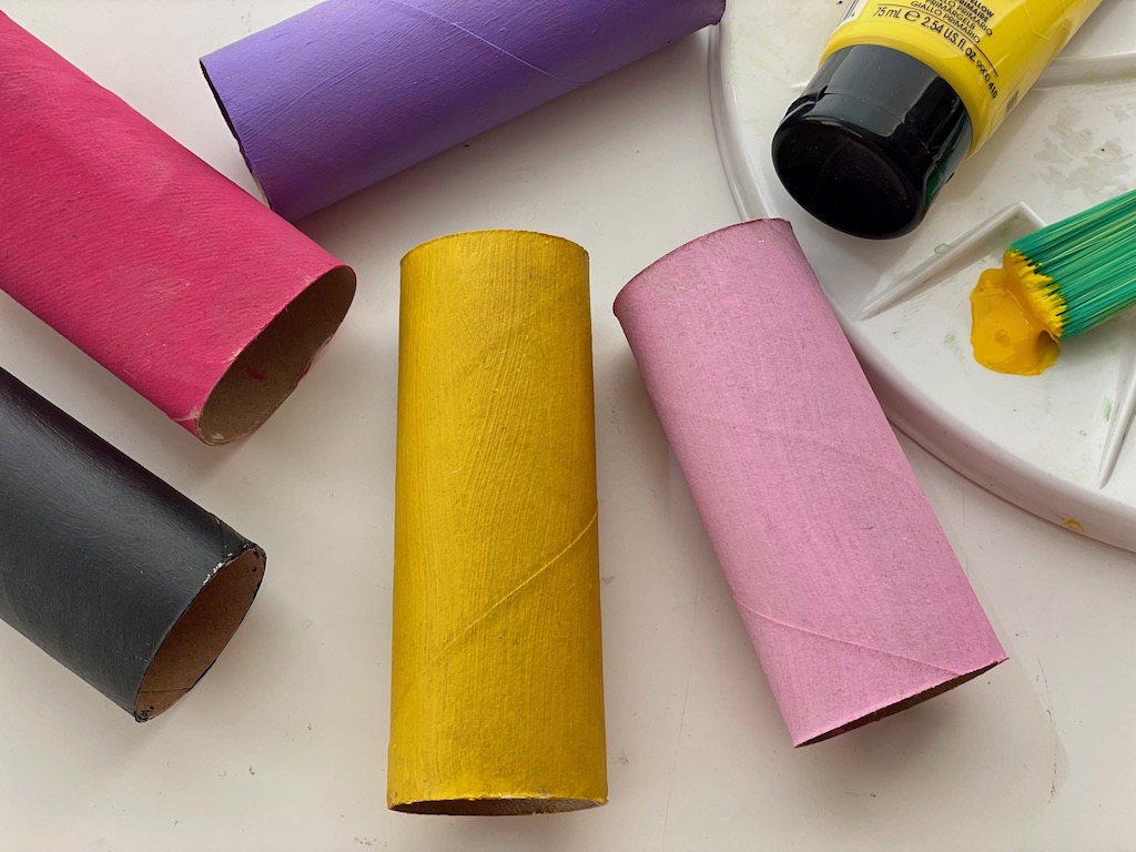 Use leftover acrylic paint to paint toilet paper rolls to use for another project.