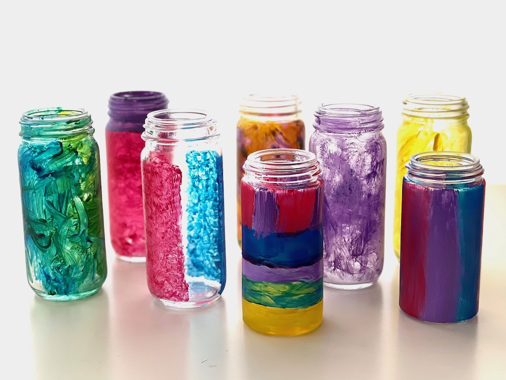 Paint spice jars with acrylic paint to turn them into vases for a Mother's Day gift.
