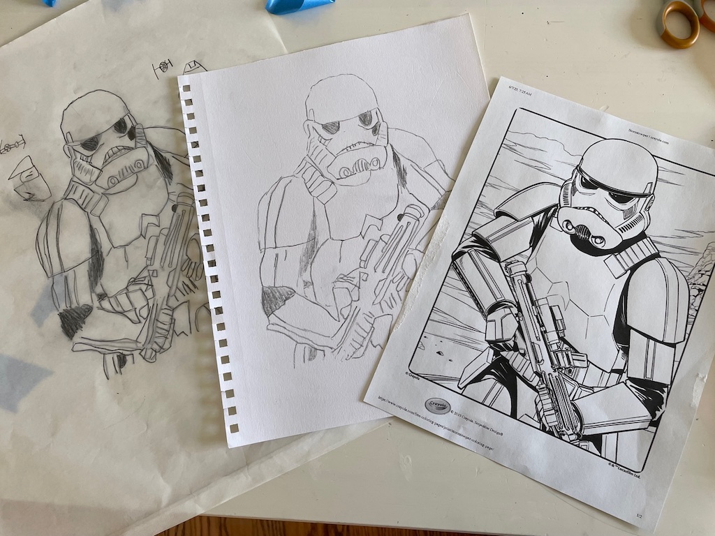 From left to right: tracing of a storm trooper by a child on tracing paper, transfer of the tracing to art paper, and the original art.