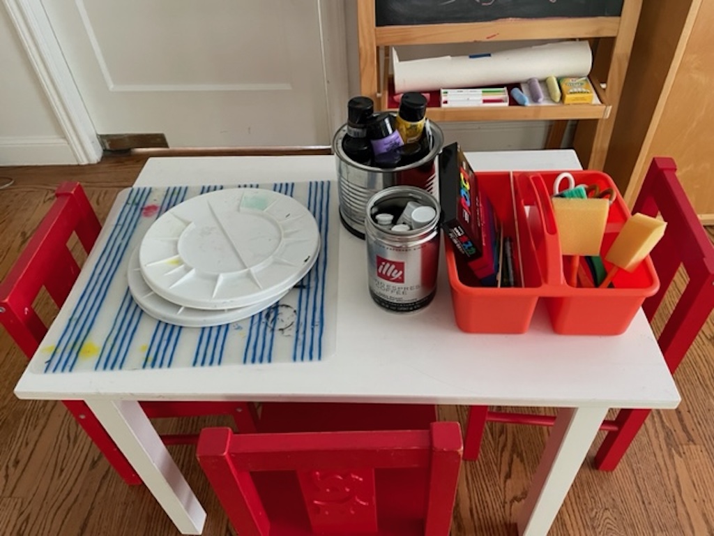 Set up a work table with old plastic placemats to protect surfaces, paint palettes, acrylic paints, and tools.