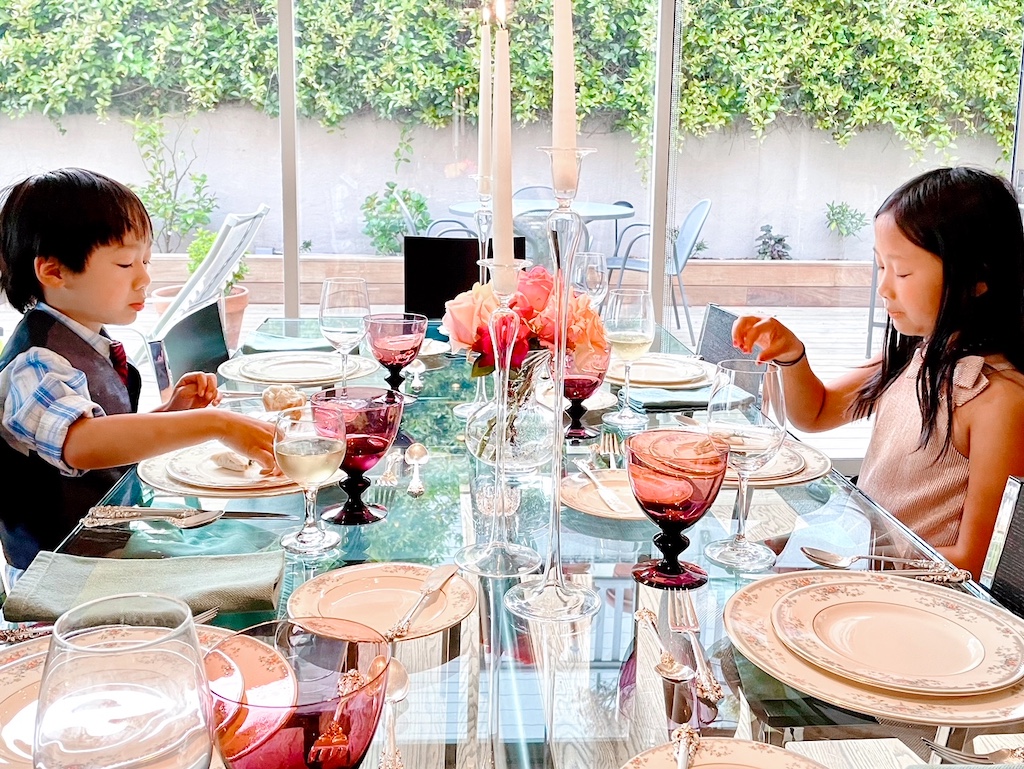 Kids having a fancy dinner at grandma's to learn proper behavior and dining etiquette.