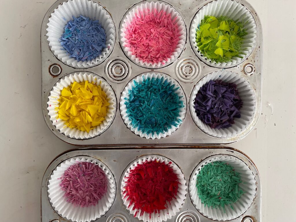 Crayon shavings in cupcake liners, set in muffin tins.