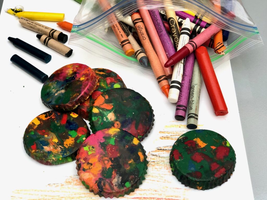 Multicolored crayon disks are made from melting crayon stubs together and heating in a muffin tin.