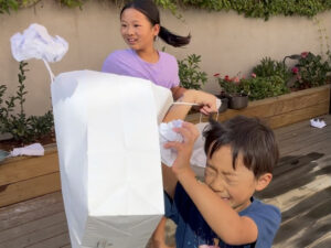 Kids ducking recycle paper wads as they try to capture the flag.