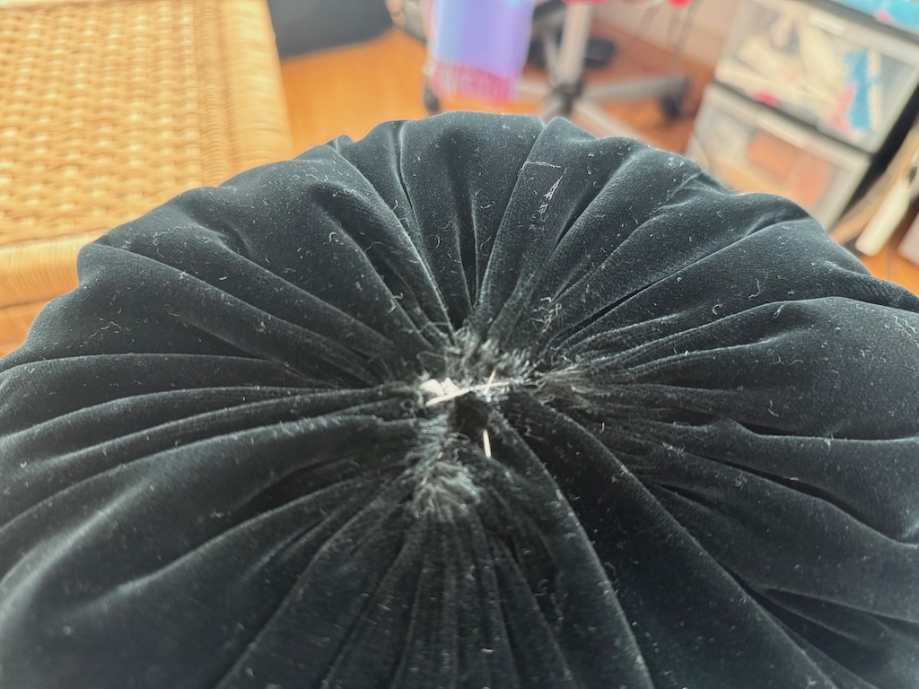 Take stitches from one side of the opening to the other to tighten the gathers and close the hole.