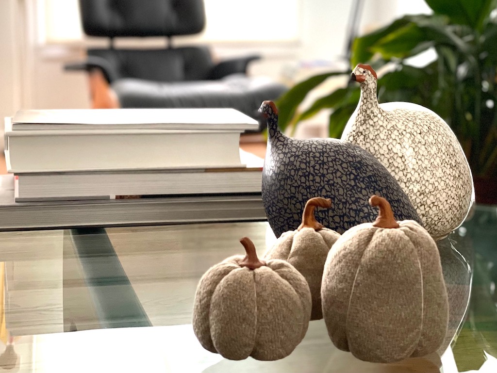 The pumpkins on a coffee table in a living room setting.