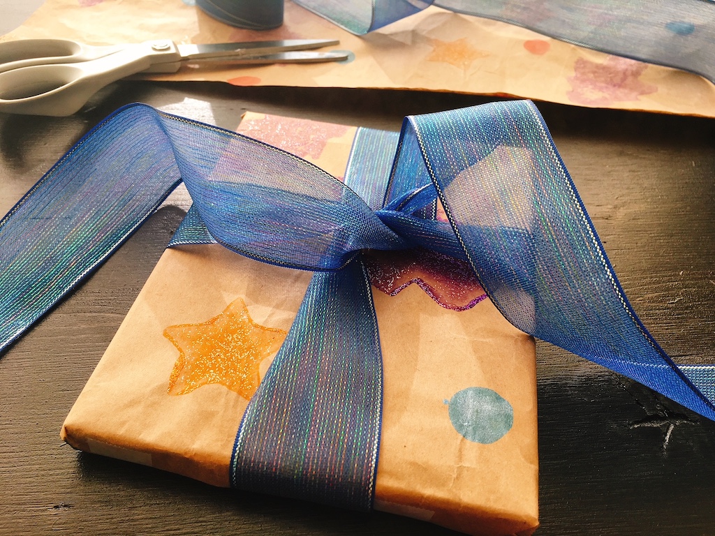 Gift wrap is made from throwaway paper stuffing and potato stamps.