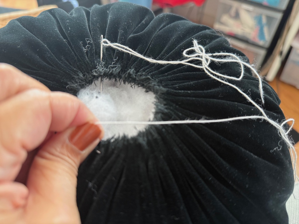 Pull gathers of running stitch to close the hole.