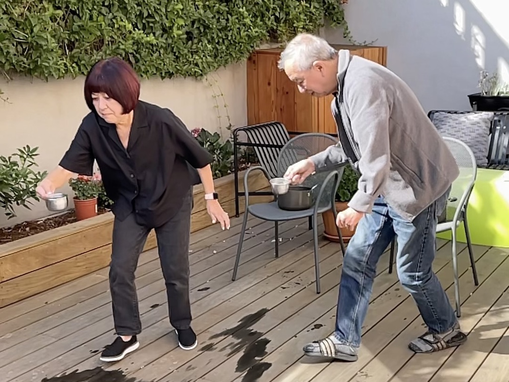 Grandma and grandpa race to take measuring cups of water back to their team for this relay race.