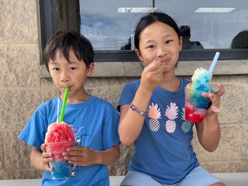 Kids eating shave ice.