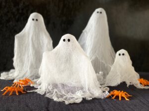 These ghosts are made with cheesecloth, white glue, and black felt scraps.