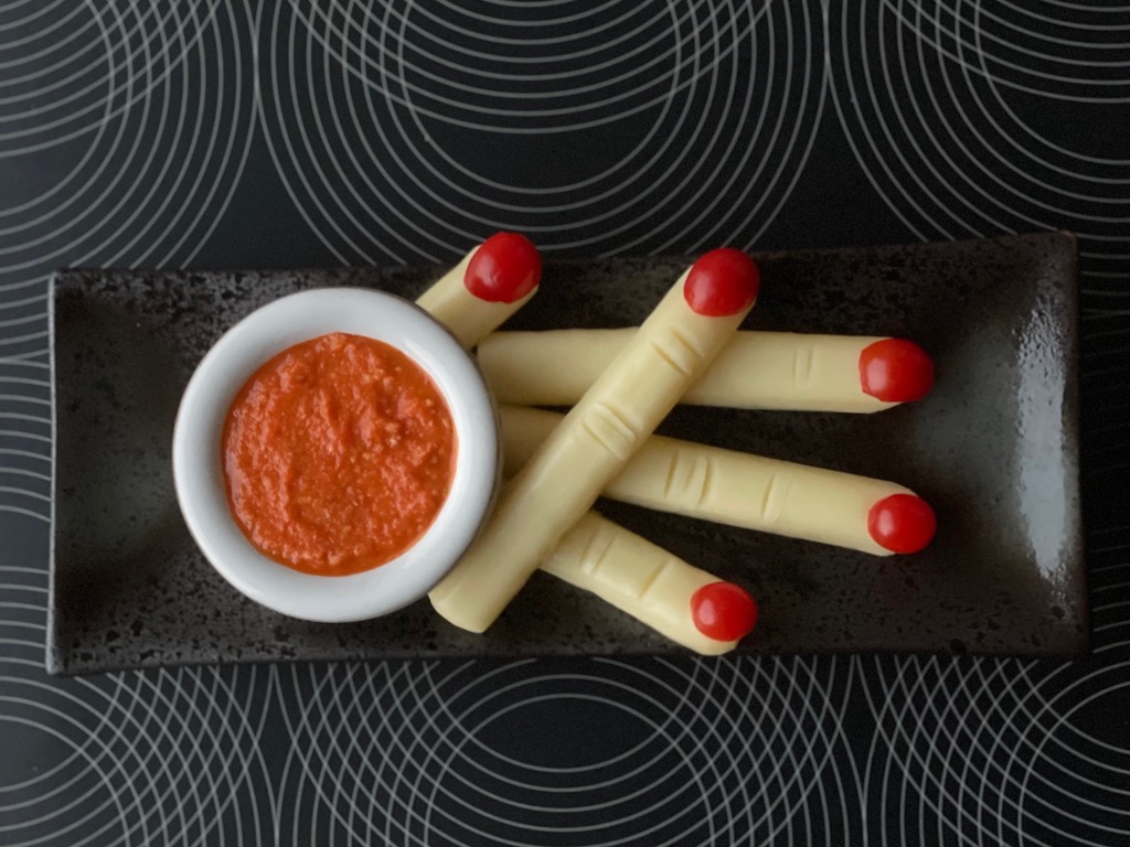 Best Halloween idea: String cheese and cherry tomato halves are used to make Creepy Fingers; "Blood" Dip is romesco sauce.